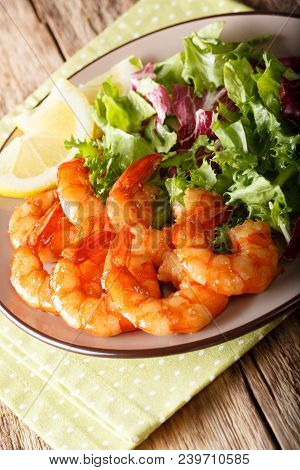 Shrimp Fried In Soy Sauce And Fresh Salad Close-up. Vertical