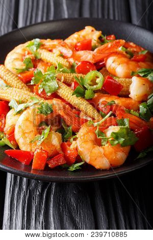 Portion Of Spicy Shrimp With Pepper, Garlic, Corn Cob And Herbs Close-up. Vertical