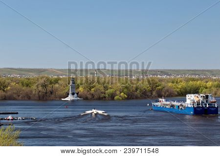 The Barge For Transportation Of Oil Products Turns From The Riverbed Of The Volga Near The Lighthous