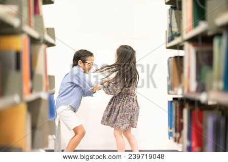 Happy Kids Lifestlye In The Library. Young People Explore Lifestlye In The Library. Development Of H