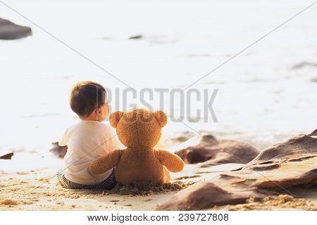 Baby And Teddy Bear Sit Togather On The Beach, This Immage Can Use For Kid, Friend, Love, Travel, Lo