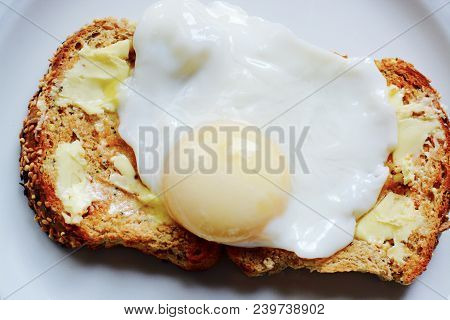The Perfect Poached Egg On Seeded Buttered Brown Toast