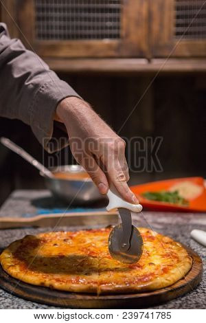 Chef Using Pizza Wheele To Cut Cheese Pizza Base, Copy Space