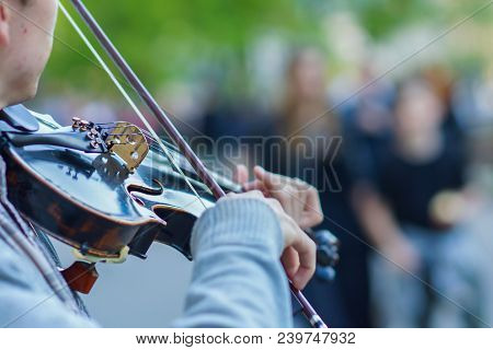 The Violin Is Big, Against The Backdrop Of The Street
