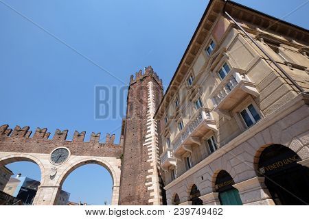 VERONA, ITALY - MAY 27: Corso Porta Nuova street and medieval Gates Portoni della Bra on Piazza Bra in Verona, Italy, on May 27, 2017.