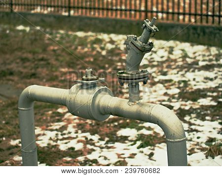 Flanges And Valves Are Mounted On A Ground Made Of Welded Steel Pipes. Metal Pipe Flanges With Bolts