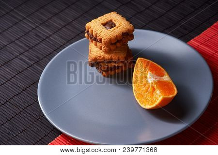 Group Of Chocolate Halloween Cookies On Plate And Red And Black