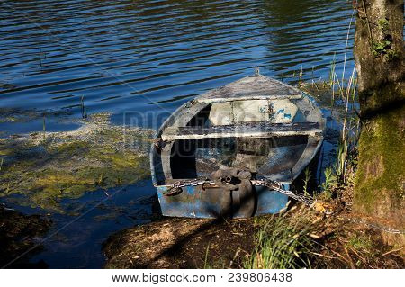 A Fishing Boat Moored To The Shore Of The Lake. Old Fishermen's Boat Prepared For Fishing On Lakes.