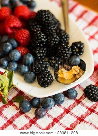 Macro View Of Blackberries, Blueberries, Raspberries And Muesli