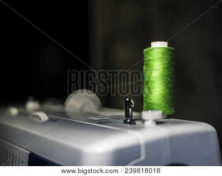 Colourful Thread Spool On Top Of Sewing Mahine