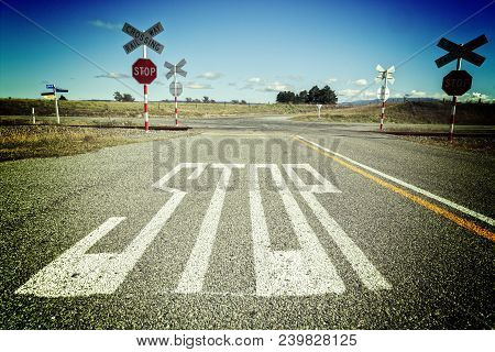 Stop Written On Road At Level Crossing - Uncontrolled Level Crossing In Rural Canterbury, New Zealan