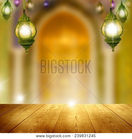 Ramadan Kareem background.Mosque window with lantern lightning and wooden table