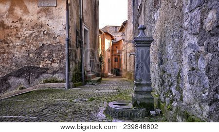 Old Water Pump From Metal In A Quiet And Old Street Italy