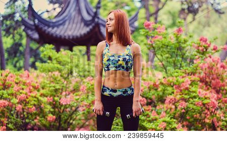 Redhead Female Doing Youga In A Summer Park.