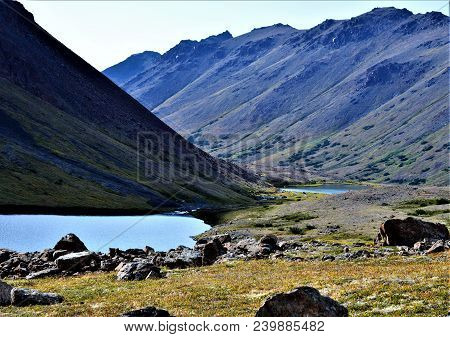 Chugach National Forest Above Anchorage, Alaska.  Landscape
Of Mountains And Creek Running To The Oc