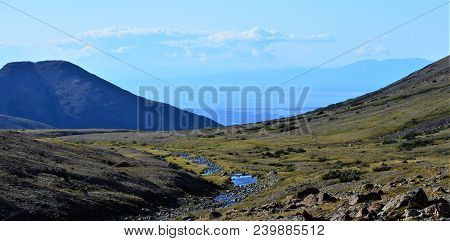 Chugach National Forest Above Anchorage, Alaska.  Landscape
Of Mountains And Creek Running To The Oc
