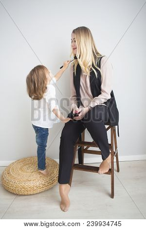 Mother And Daughter Doing Make Up Oto Each Other. Family Fun Concept