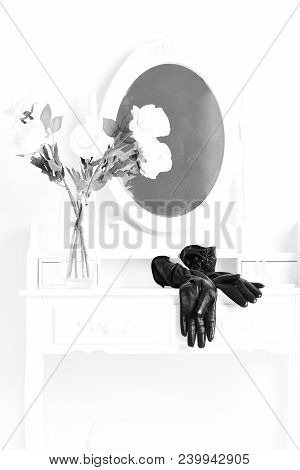 Black Leather Glovers Lying Near Transparent Vase With Roses On Vintage Female Boudoir With Console 