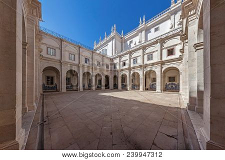 Lisbon, Portugal - September 9, 2013: Cloister of Mosteiro de Sao Vicente de Fora Monastery in 17th century Mannerism style. White limestone.