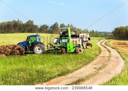 Natural Manure Agro Bio Fertilization. Loading Manure Onto Tractor. Agricultural Landscape In The Cz