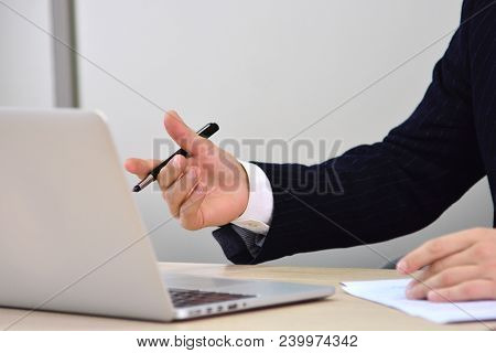 Concentrated Businessman With Laptop At Work In The Office. Businessman Creates An Idea For Future P