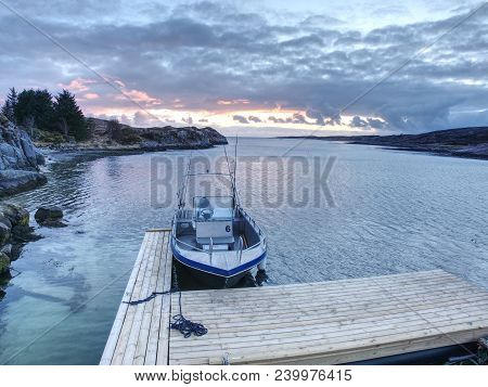 Fishing Boat With Fishing Rods Floating At Shore, Evening Colorful  Sea. Background Beautiful Sky