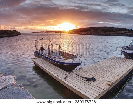 Sport Fishing Boat Anchored Back In Port After Day At Sea. Colorful Sunset At Horizon. Empty Floatin