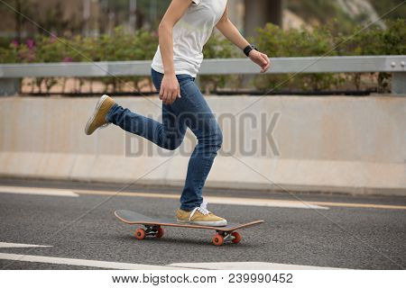 One Young Woman Skateboarder Sakteboarding On Highway