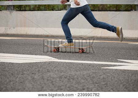 One Young Woman Skateboarder Sakteboarding On Highway