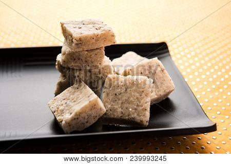 Fresh Nariyal Barfi / Coconut Burfi Or Khobra Vadi, Served In A Bowl Or Plate Over Decorative Backgr
