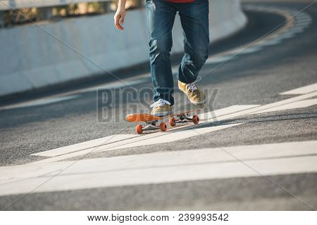 One Young Woman Skateboarder Sakteboarding On Highway