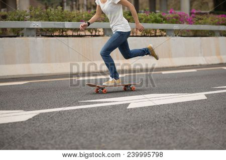 One Young Woman Skateboarder Sakteboarding On Highway