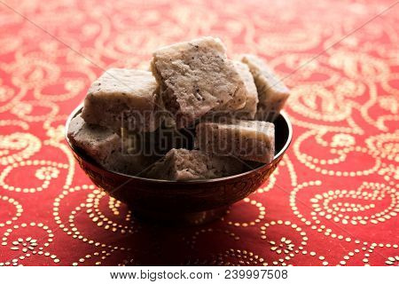 Fresh Nariyal Barfi / Coconut Burfi Or Khobra Vadi, Served In A Bowl Or Plate Over Decorative Backgr