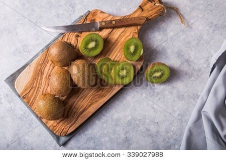 Kiwi Fruit. Fresh And Juicy Kiwi Fruit And A Half On Cutting Board.  Sweet And Sour Taste And Have H