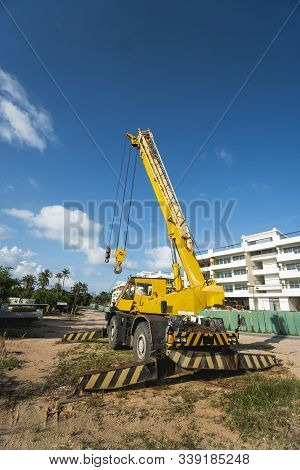 Yellow Automobile Crane With Risen Telescopic Boom Outdoors. Mobile Construction Crane On A Construc
