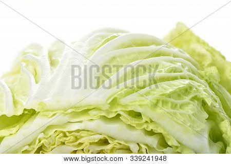Macro Shot Of A Surface Of Lettuce. Chinese Cabbage On A White Background.