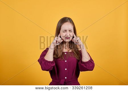 Young Lady In Burgundy Bluse With Bow Over Isolated Orange Background Frustrated And With Closed Eye