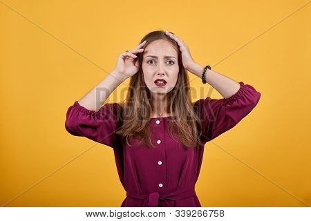 Woman With Tired And Sick Expression Holds Der Hands On Head. She Is Tired And Maybe Has Fever. She 
