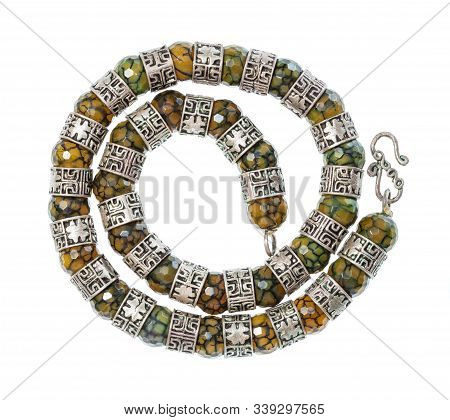 Top View Of Antique Arabic Spiral Necklace From Faceted Jadeite Gems And Silver Rings Isolated On Wh