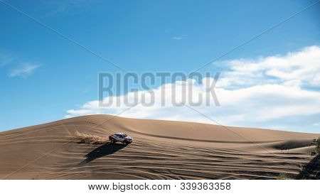 On Sand Dunes In Lut Desert With A Dakar Edition Race Car