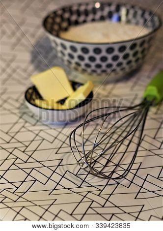 Baking Equipment And Ingredients In Kitchen. Green Whisk, Butter, Fluor In Black And White Bowls