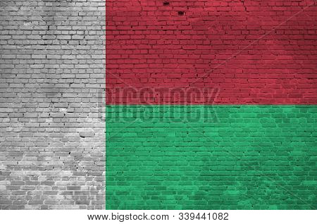 Madagascar Flag Depicted In Paint Colors On Old Brick Wall. Textured Banner On Big Brick Wall Masonr
