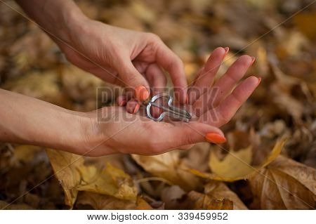 Female Hands Are Holding Traditional Hutsul Drymba Or Jews-harp, The Oldest Musician Instrument In T