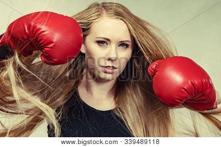 Bloned Long Hair Girl Boxer In Big Fun Red Gloves Playing Sports Boxing. Female Fight For Equal Righ