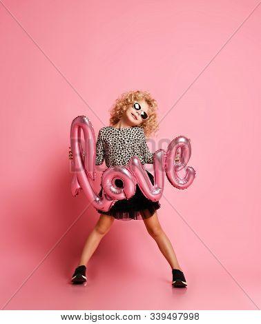 Glamorous Blonde Kid Girl With Curly Hair And In Leopard Print Shirt, Fatin Skirt And Sunglasses Is 
