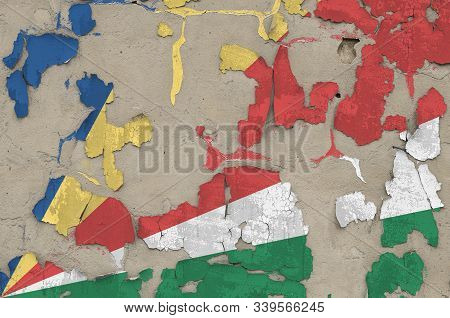 Seychelles Flag Depicted In Paint Colors On Old Obsolete Messy Concrete Wall Closeup. Textured Banne