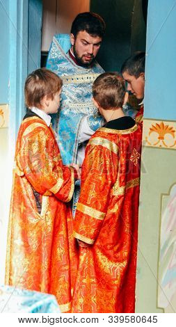 Voyutyn, Volyn / Ukraine - October 14 2008: Orthodox Priest And Little Sextons At Local Church