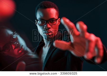 Trying To Reach You. Beautiful Refrection. Futuristic Neon Lighting. Young African American Man In T