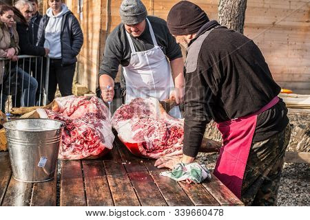 Butchers Slaughtering A Pig