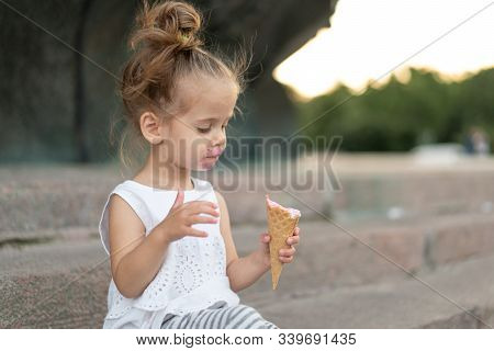 Little Caucasian Girl 3 Years Old Eats Ice Cream Closeup Portrait. Summertime. Childhood Child With 